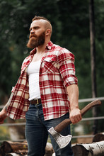 Portrait Of Bearded Woodcutter Man With Axe Outdoor Landscape Background