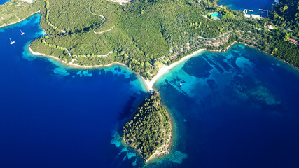 Wall Mural - Aerial drone bird's eye view panoramic photo of iconic island of Skorpios that was owned by Aristotle Onasis and port of Nidri at the background, Lefkada island, Ionian, Greece