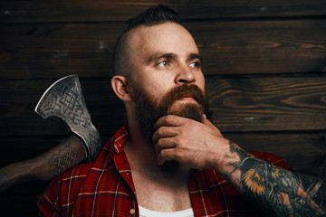 Wall Mural - bearded mohawk male holding axe and posing in studio