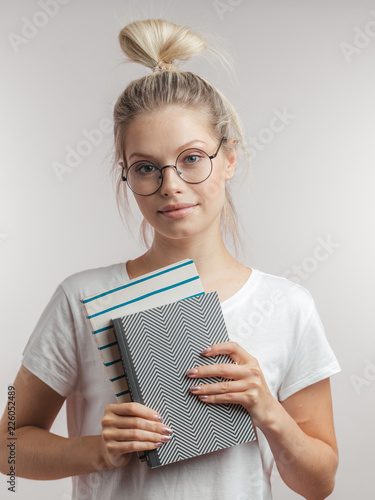 Positive Young Teacher Female With Blonde Hair Knot On Head