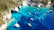Aerial Drone Photo Of Sail Boats Anchored In Tropical Caribbean Paradise Bay With White Rock Caves And Turquoise Clear Sea