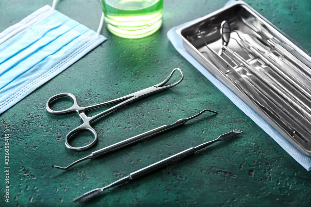 Dentist's tools with tray on color table