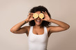© Prostock-studio - African-american woman with lemon halves near eyes