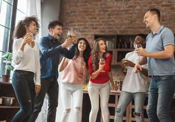 Group of excited friends partying at home