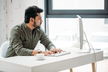 creative man with pc computer working at modern office