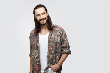 Isolated shot of young handsome male with beard, mustache and trendy hair, funny joyfull expression, poses in studio against white background. Confident young designer stylist