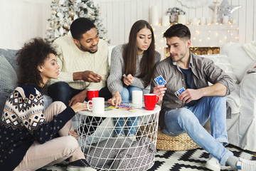 Group of friends relaxing and playing cards together