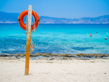 Chrissi Island, Crete, Greece. A Lifebuoy On The Golden Beach, Symbol Of Assistance, Security, Rescue, SOS. Golden Beach In Chrysi Island, One Of The Wildness And Gorgeus Beach In The World