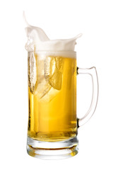 Wall Mural - Cold beer splash out of mug isolated on white background.