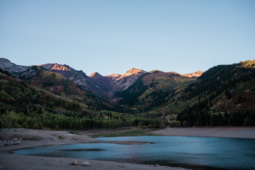  Mountain Peaks Lit by a Sunset about a Alpine Lake in Utah