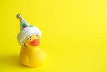 Christmas Rubber Duck Toy For Swimming On Yellow Background.