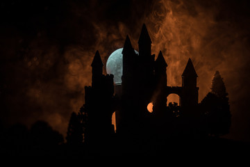 Wall Mural - mysterious medieval castle in a misty full moon. abandoned gothic style old castle at night
