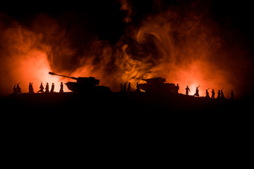 War Concept. Military silhouettes fighting scene on war fog sky background, World War German Tanks Silhouettes Below Cloudy Skyline At night. Attack scene. Armored vehicles.