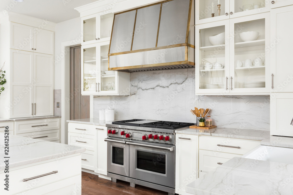 White Kitchen Detail  in New Luxury Home: Oven, Range, Hood, and Countertops - obrazy, fototapety, plakaty 