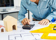 © Phushutter - Young Asian man architect working at working desk about his housing project.