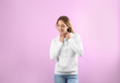© New Africa - Portrait of woman in hoodie sweater on color background. Space for design