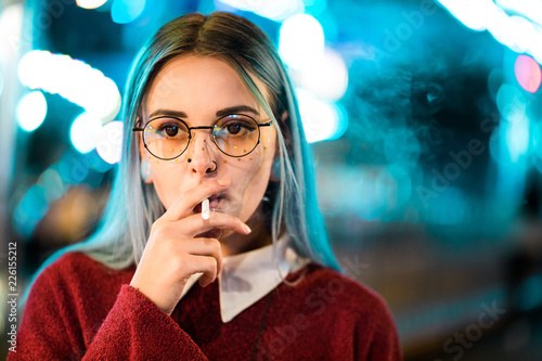 Millennial Pretty Girl With Unusual Dyed Hairstyle Smoking