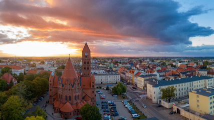 Wall Mural - The Roman Catholic Co-Cathedral St. Stanisław Biskupa Martyr in Ostrow Wielkopolski, Poland. Aerial view to church and old town during sunset.