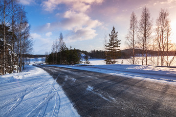 Wall Mural - Empty rural road on a lake coast, winter