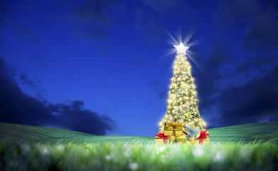 Wall Mural - Conceptual decorated shiny Christmas tree on green landscape over clear night sky