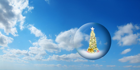 Wall Mural - conceptual image of decorated christmas tree in glass sphere floating in air over sunny sky