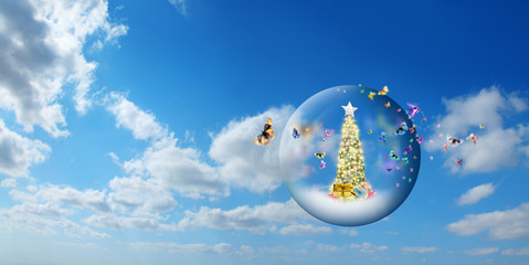 Wall Mural - decorated christmas tree in glass sphere with group of butterflies floating in air over sunny sky