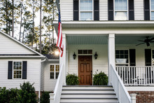 Front Porch With Stairs Of All American White Farmhouse With Wood Doors
