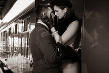 Vintage Couple Embracing On Railway Station Platform As Train Is About To Depart