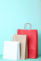  Colorful paper shopping bags on mint background
