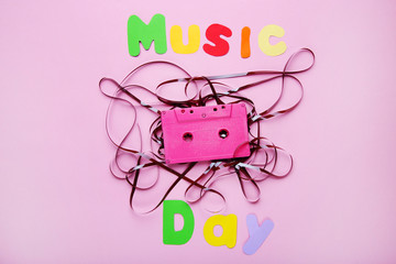 Cassette tape with inscription Music Day on pink background