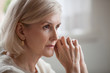 © fizkes - Thoughtful serious anxious mature senior woman feeling blue worried about problems, pensive upset sad middle aged grey haired lady looking away thinking of loneliness, getting older and depression