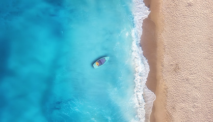 Wall Mural - boat on the water surface from top view. turquoise water background from top view. summer seascape f