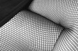 sexy women's legs in black fishnet stockings texture