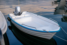 Blue White Power Boat Stops At The Port  Small Motor Boat On A Calm , Silent Sea Reflections  Motorized Boat And Sea At Sunset