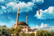 Beautiful mosque under the blue sky with seagulls.