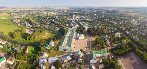 Wall Mural - Beautiful panoramic view of Suzdal in summer at sunrise. Resurrection Church on the market square in Suzdal. Suzdal is a famous tourist attraction and part of the Golden Ring of Russia