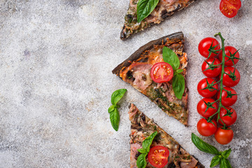 Wall Mural - Pieces of  black pizza with tomatoes and basil