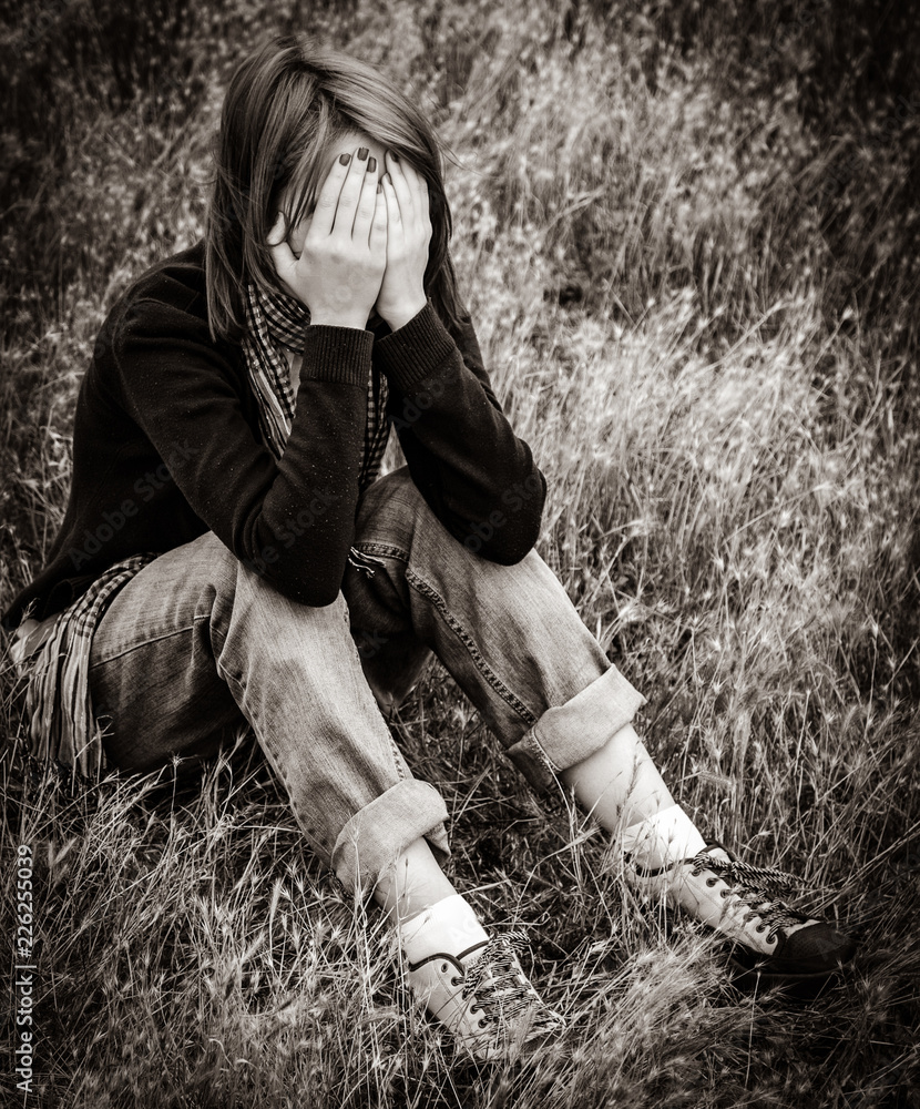 Lonely sad girl sitting at ground. Image in black and white color style  Stock Photo | Adobe Stock, image size:830x1000