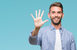 © Krakenimages.com - Young handsome man wearing white t-shirt over isolated background showing and pointing up with fingers number five while smiling confident and happy.