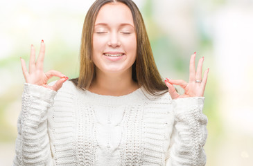 Young beautiful caucasian woman wearing winter sweater over isolated background relax and smiling with eyes closed doing meditation gesture with fingers. Yoga concept.