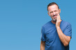 © Krakenimages.com - Middle age hoary senior man over isolated background touching mouth with hand with painful expression because of toothache or dental illness on teeth. Dentist concept.