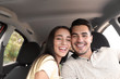 © New Africa - Happy young couple in car on road trip