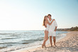 © New Africa - Romantic young couple spending time together on beach. Space for text