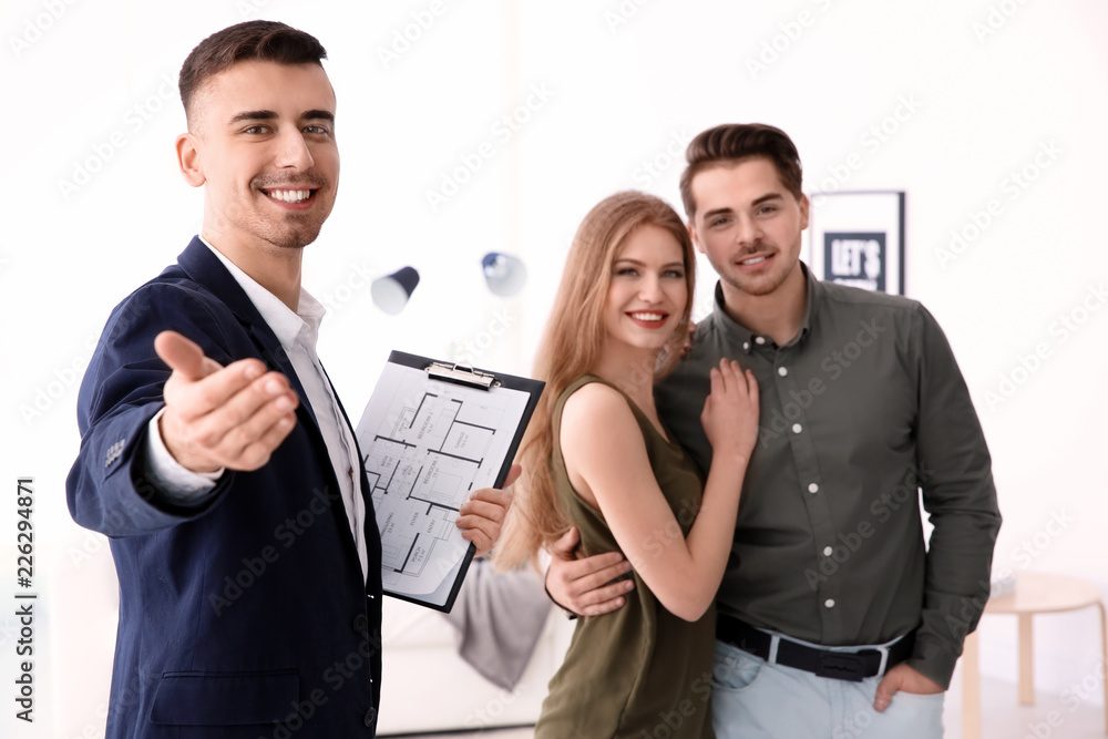 Real estate agent with clients in new house
