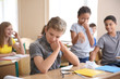 © Africa Studio - Children bullying teenage boy in classroom