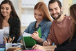 © Africa Studio - Students doing homework together in library