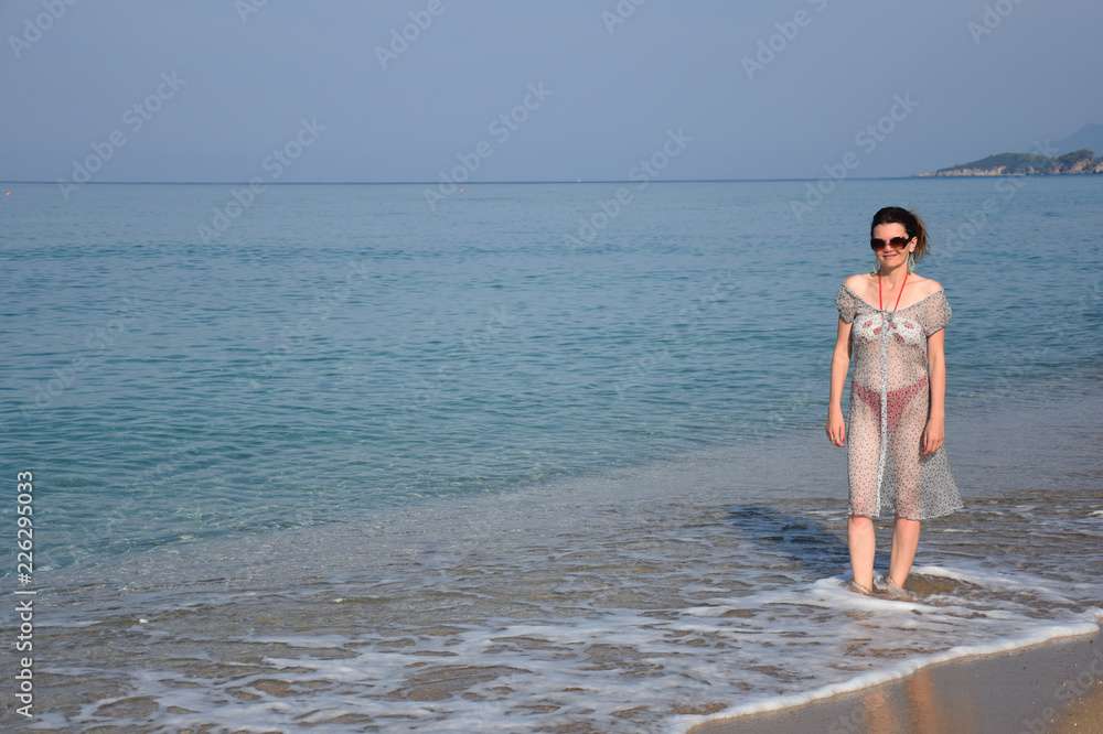 Middle aged woman in a transparent dress on beach. Woman relaxing on a sandy beach Stock Photo | Adobe Stock Middle aged woman in a transparent dress on beach. Woman relaxing on a sandy beach Stock Photo | Adobe Stock