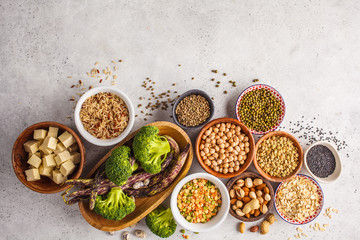 Wall Mural - Vegan protein source. Tofu, beans, chickpeas, nuts and seeds on a white background, top view, copy space.