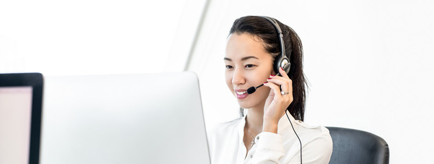 Smiling asian beautiful friendly woman in call center banner background