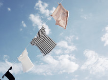 Blowing Hung Out To Dry Cloths In The Bright Sky And Warm Sun         